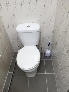 a bathroom with a white toilet in a room at Angela's Place in Durban