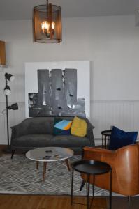 a living room with a couch and a table at Hotel Cap-aux-Pierres in L'Isle-aux-Coudres