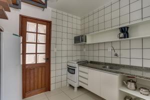 a kitchen with a sink and a stove at Pousada Saint Paul in Florianópolis +30 photos