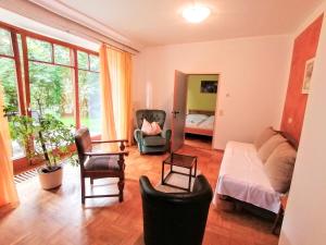 a living room with a couch and chairs at Gartenapartment in Zell am See