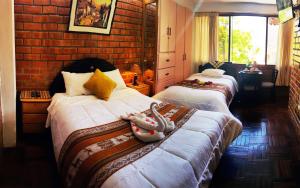 Postel nebo postele na pokoji v ubytování Hostal Comarca Imperial
