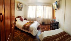 Postel nebo postele na pokoji v ubytování Hostal Comarca Imperial
