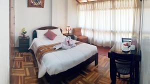 Postel nebo postele na pokoji v ubytování Hostal Comarca Imperial