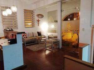 a living room with a couch and a table at Casa Tréveris in Sucre +56 photos