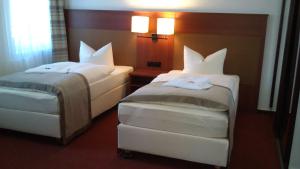 
Ein Bett oder Betten in einem Zimmer der Unterkunft Hotel Boizenburger Hof
