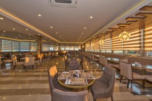 a restaurant with tables and chairs and windows at Bekdas Hotel Deluxe & Spa in Istanbul