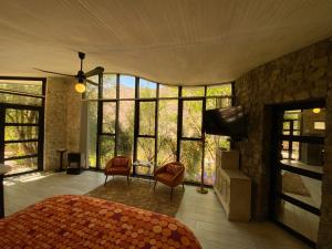 a bedroom with a bed and a flat screen tv at Cabañas Caballieri in Pisco Elqui