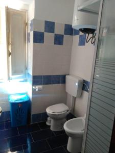 a bathroom with a toilet and a glass shower at Ca Rosella in Sorso