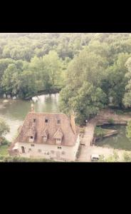an aerial view of a house in the middle of a river at Charmant Moulin avec SPA 15 min de Tours in Montbazon