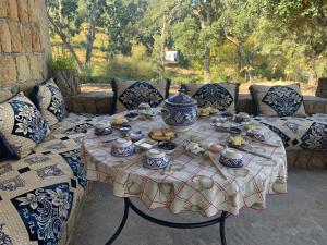 a table with food and tea set on it at Maison d'hôtes "Abou-Hachem" in Lahcene