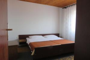 a bedroom with a large bed in a room at Apartments Marin - 100m from beach in Tkon