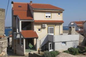 a house with a red roof at Apartments Marin - 100m from beach in Tkon