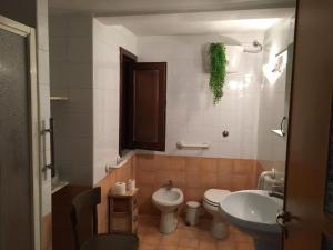 a bathroom with a sink and a toilet and a sink at Casa 900 in Pompei