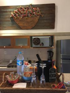 a kitchen counter with a table with food and a basket of food at Praia do Forte Apartamento Fantástico in Praia do Forte