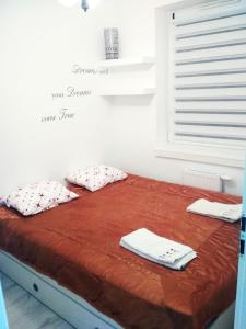 ein Bett in einem Zimmer mit einem Fenster mit Handtüchern darauf in der Unterkunft Apartament ul Mlynowa i parking podziemny in Białystok