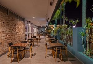 a row of tables and chairs in a restaurant at Palms Hotel in Sydney