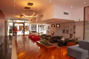 a large living room with couches and people in it at Apartamento Canciller in Buenos Aires