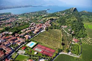 an aerial view of a town with trees and the water at Agriturismo La Filanda in Manerba del Garda