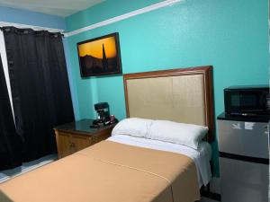 a small bedroom with a bed and a tv at Sunnyside Hotel-Downtown San Francisco in San Francisco