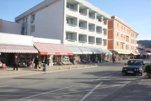 a car driving down a street next to a building at Guest House Mačun in Međugorje