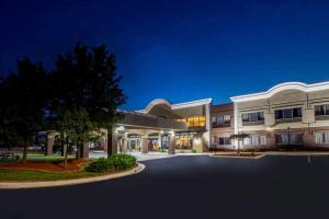 an exterior view of a building at night at Days Inn & Suites by Wyndham Rochester Hills MI in Rochester Hills