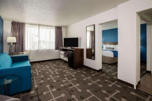 a hotel room with a bed and a television at Baymont by Wyndham Spokane in Spokane