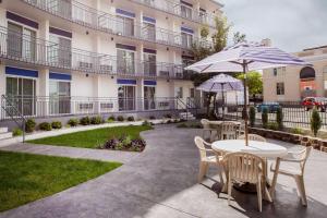 a patio with a table and chairs and an umbrella at Baymont by Wyndham Spokane in Spokane
