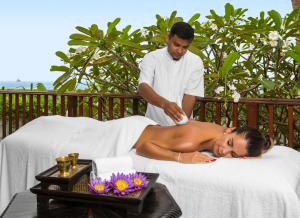 a man giving a woman a massage on a bed at Thambili House Galle Fort by Edwards Collection in Galle