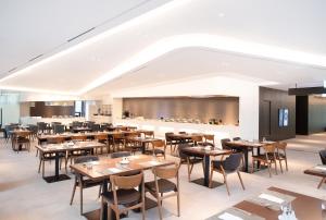 a restaurant with tables and chairs and a bar at Orakai Daehakro Hotel, BW Signature Collection in Seoul