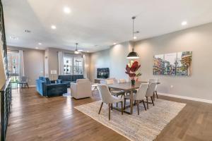 a dining room and living room with a table and chairs at Stunning Villas with Modern & Open Layout in New Orleans