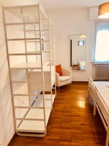 a room with a white book shelf next to a bed at Lund Home in Verona
