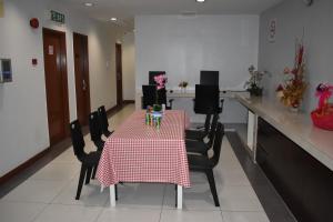 a table with chairs and a red and white table cloth at WL HOTEL in Kampung Baharu Sungai Buluh