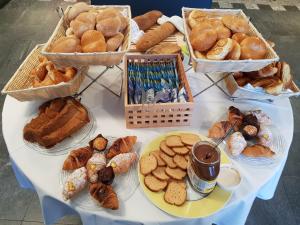a table with many different types of bread and pastries at Hotel Pestalozzi Lugano in Lugano