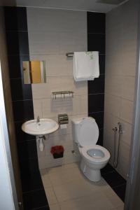 a small bathroom with a toilet and a sink at WL HOTEL in Kampung Baharu Sungai Buluh