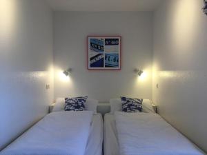 Zimmer mit 2 Betten und einem Bild an der Wand in der Unterkunft of un an in Greetsiel