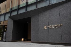 a building with a sign on the front of it at THE BLOSSOM HAKATA Premier in Fukuoka