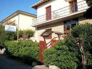 a hotel with an orange gate in front of a building at Hotel Signorini in Castiglioncello