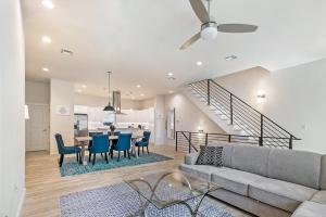 a living room with a couch and a table and chairs at Mid City Fully Furnished Townhouse in New Orleans