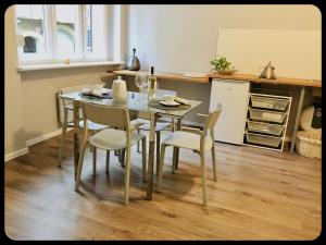 a dining room table and chairs in a kitchen at Apartamenty 8 in Poznań