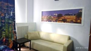 a living room with a couch and a table at Economy Hotel Lira in Saint Petersburg