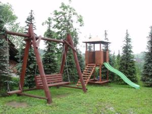 a playground with a swing and a slide at GÓROLIK u Kwietniów-nocleg & śniadanie, tel 18-20-010-31 in Bukowina Tatrzańska