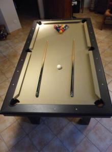 a pool table with three cue sticks on it at AU CLOS DE L'ETANG in Ravel