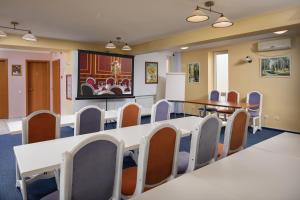a conference room with chairs and a table and a table and chairs at Grand Hotel in Braşov +37 photos