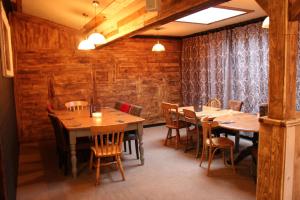 a dining room with wooden tables and chairs at Life Begins @ 40 Sun Valley Park in St Austell