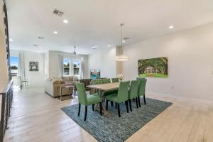 a dining room and living room with a table and chairs at New Construction Townhouse Near City Hot Spots in New Orleans