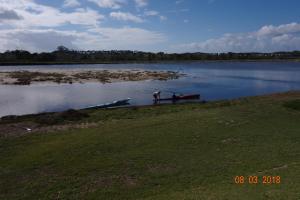 two people in a boat on a lake at Twin Rivers Villa in Plettenberg Bay
