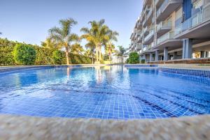 a swimming pool in front of a building at Apartment BlueHat Moncofa in Moncófar