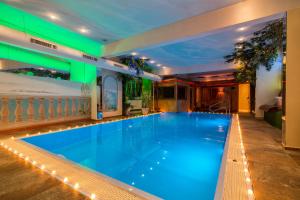 a large swimming pool in a hotel with a green ceiling at Hotel Engel in Sluderno