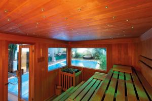 a sauna with a bench and a swimming pool at Hotel Engel in Sluderno