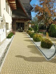 a brick walkway in front of a building at Perła Podhala in Szaflary